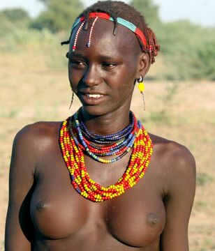 Nude ebony tribal femmes and one